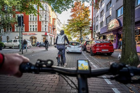 Cycling in the city, city centre road, cycle lane, two-wheeled traffic has priority, 30 km/h zone,