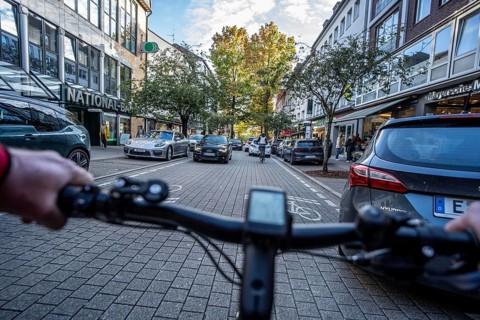 Cycling in the city, city centre road, cycle lane, two-wheeled traffic has priority, 30 km/h zone,