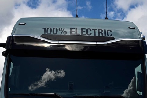 A sign on an electric lorry states that the vehicle is 100 percent electrically powered. The