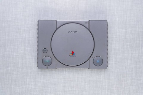 Top shot of a Playstation 1 on a white Resopal board