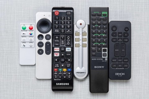 Top shot of a series of remote controls on a white Resopal panel