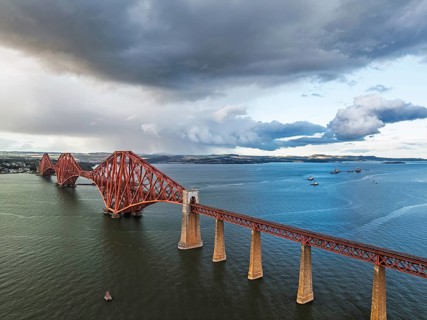 Rain clouds over Forth Bridge from a drone, Queensferry Crossing, Forth Estuary, Scotland, United