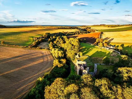 Ruins of Hailes Castle over River Tyne from a drone, East Linton, East Lothian, Scotland, UK