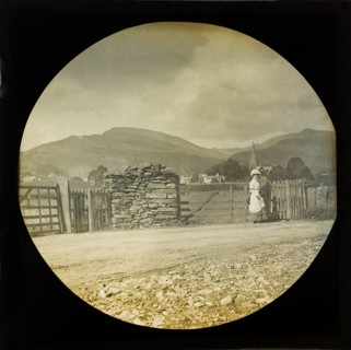 Woman Victorian or Edwardian tourist with background of Ambleside, Lake District, Cumbria, England,