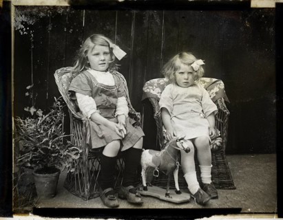 Monochrome magic lantern slide family portrait of two young girls presumably sisters circa 1900