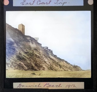 Colourised magic lantern slide of ruin of All Saints church on clifftop at Dunwich, Suffolk,