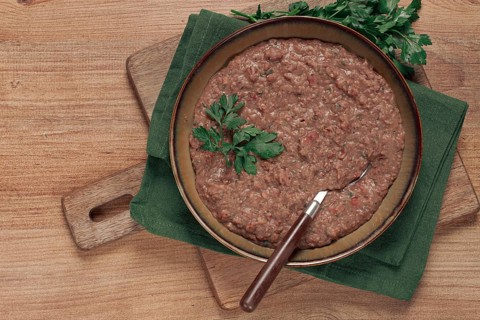 Red bean lobio, a traditional Georgian dish, on a wooden table, homemade