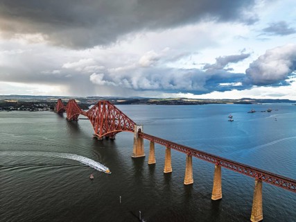 Rain clouds over Forth Bridge from a drone, Queensferry Crossing, Forth Estuary, Scotland, United