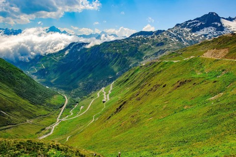 View to the left in the background at the lower cloud line Grimselpass, in front mountain pass
