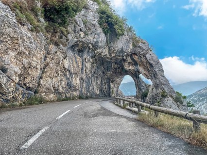 View from moving car on double rock arch rock gate Arches de Gréolières in on the Route de Gentelly