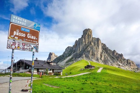 Sign at the top of the Alpine pass road Passo Giau, on the right summit of Monte Gusela Ra Gusela,