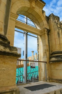 View through former arched window of ruins of former opera house Royal Opera House of Valletta