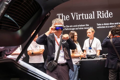 Mercedes trade fair stand with virtual presentation. Trade fair visitors with 3D glasses. The