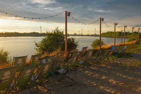 View from the outdoor area of a restaurant at Lankenauer Höft over deckchairs through a string of