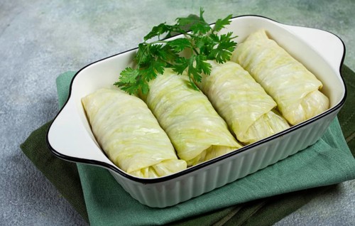Raw cabbage rolls, not cooked, with minced meat, top view, without people, in the spotlight