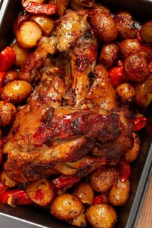Pork knuckle, baked with vegetables, new potatoes, on a baking sheet, homemade, no people