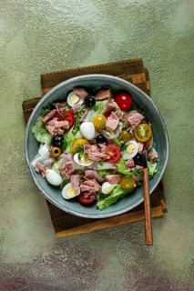 Salad with canned tuna, vegetable salad with quail eggs, lettuce, red onion, cherry tomatoes,