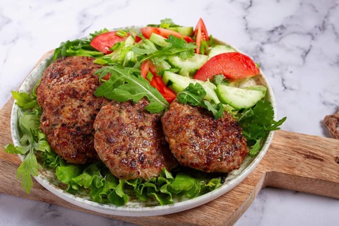 Fried cutlets, mixed minced meat, with vegetable salad, homemade, top view, no people