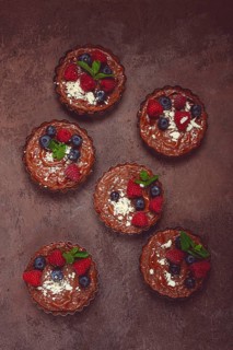 Chocolate tartlets, stuffed with cottage cheese and berries, breakfast, homemade, no people
