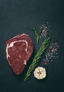 Raw steak, beef steak, rib eye steak, on the table, top view, no people, on a dark background