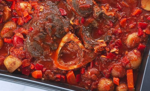 Ossobuco stew with vegetables, knuckle on the bone with new potatoes, in tomato sauce, homemade,