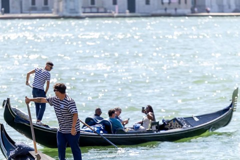Venice, Italy - 3 September 2025: Gondolier on a gondola in Venice during the 82nd Venice
