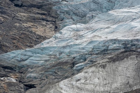 Majestic ice formations dominate the rocky terrain and show the beauty of a glacier in a secluded