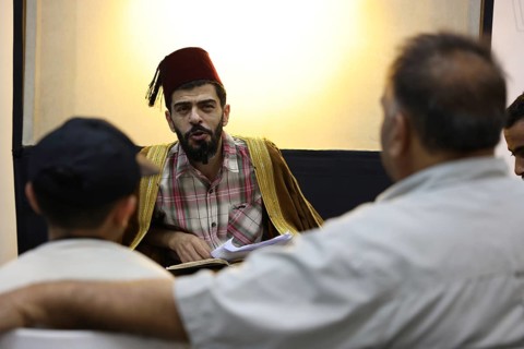 A Syrian puppeteer entertains children at the Damascus International Fair by imitating the role of