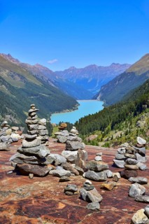 Hiking area below the Gepatsch Glacier in the Kaunertal with red rocks and the Kaunertal reservoir