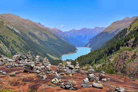 Hiking area below the Gepatsch Glacier in the Kaunertal with red rocks and the Kaunertal reservoir