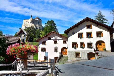 Village fountain in Tarasp, municipality of Scuol, in the background Tarasp Castle in the Lower