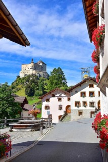 Village fountain in Tarasp, municipality of Scuol, in the background Tarasp Castle in the Lower