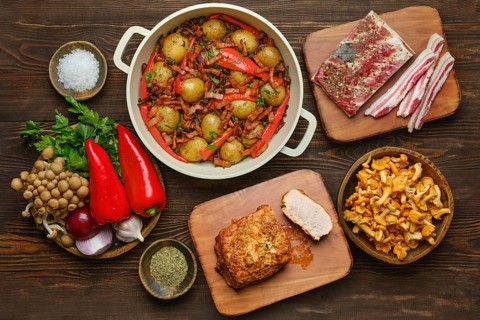 Organic ingredients on a rustic wooden countertop, showcasing a hearty meal preparation with fresh