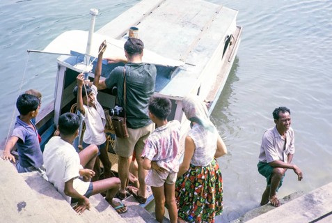 Picnic party embarking on boat for the islands, East coast, Mersing, Johor, Malaya, Malaysia, south