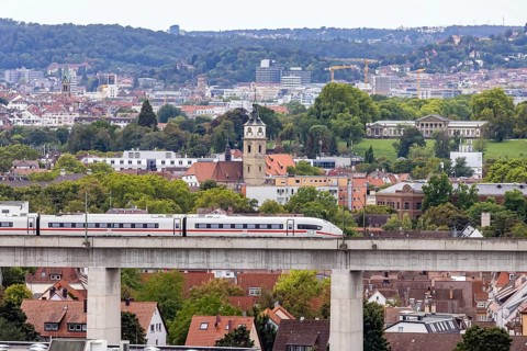 Deutsche Bahn AG ICE train travelling on the Schusterbahn, Münster viaduct with city view of Bad