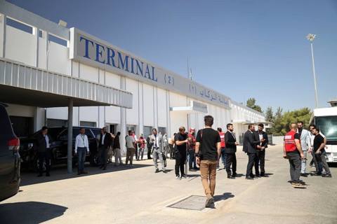 Officials from the Qatari and Syrian Red Crescents receive a Qatari airlift of aid to help the