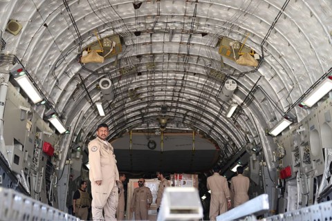 Members of the Qatari Air Force unload humanitarian aid supplies from a transport aircraft at