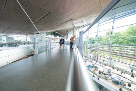 Glass balcony in a modern space with people enjoying the view, BMW Welt, Munich, Germany