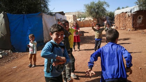 Syrian children playing in a refugee camp near the Turkish border on World Children's Day. Aleppo,