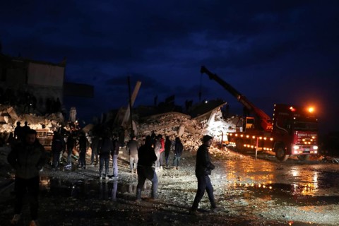 Civil defense teams attempt to rescue civilians trapped under the rubble after a powerful