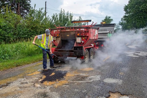Glendora, Michigan - A worker for the Berrien County Road Department patches potholes on Wagner