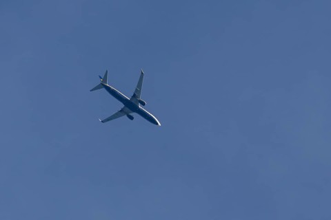 Boeing 737 jet passenger aircraft of Ryanair airlines flying in a blue sky, England, United Kingdom