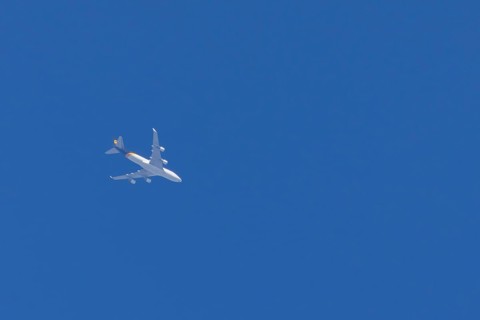 Boeing 747 jumbo jet cargo aircraft of UPS United Postal Service flying in a blue sky, England,