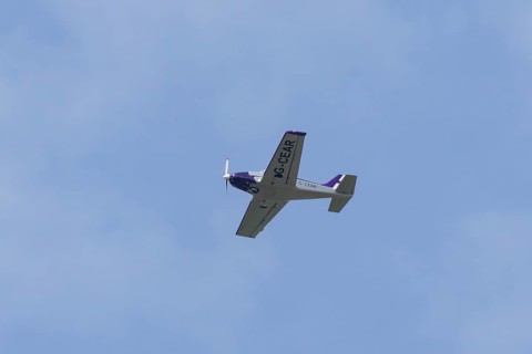 Alpi Pioneer 300 light aircraft flying in a blue sky, England, United Kingdom