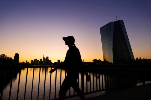 The sun sets behind the European Central Bank (ECB) and the Frankfurt banking skyline, Frankfurt am