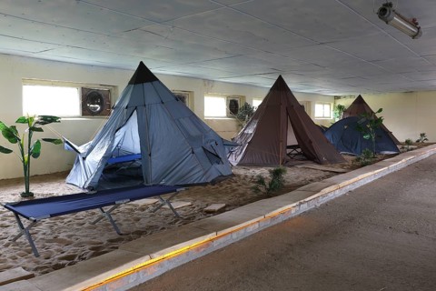 Indoor campsite in a former cattle shed at Fleether Mühle, Müritz National Park,