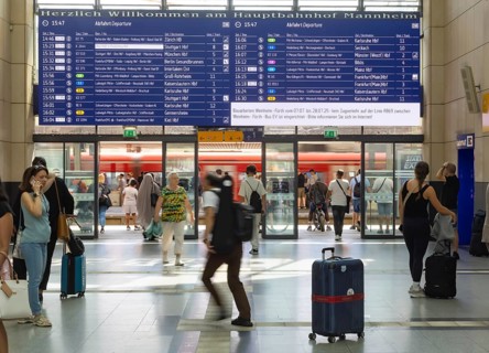 Mannheim main station, interior view with people and display board. Mannheim, Baden-Württemberg,