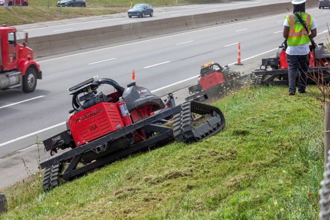 Harper Woods, Michigan - Remote-control mowers are cutting the grass and weeds along Interstate 94