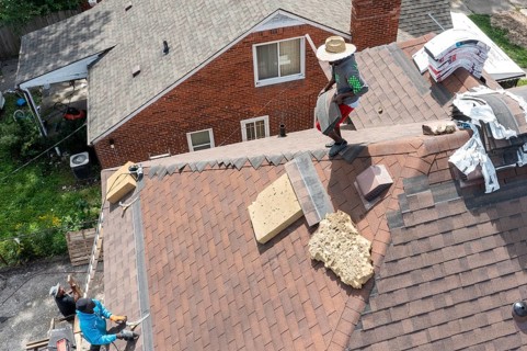 Detroit, Michigan - Workers re-roof a house they are remodeling in the Morningside neighborhood
