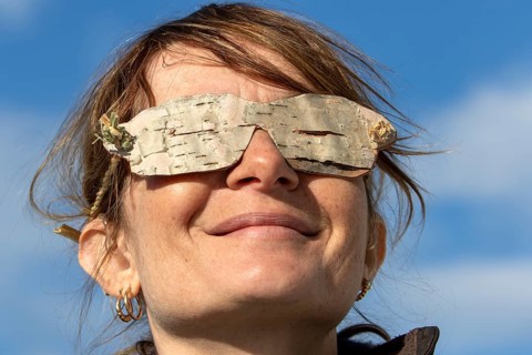 Woman wearing glasses made from birch bark, Gaspesie national park, Province of Quebec, Canada,